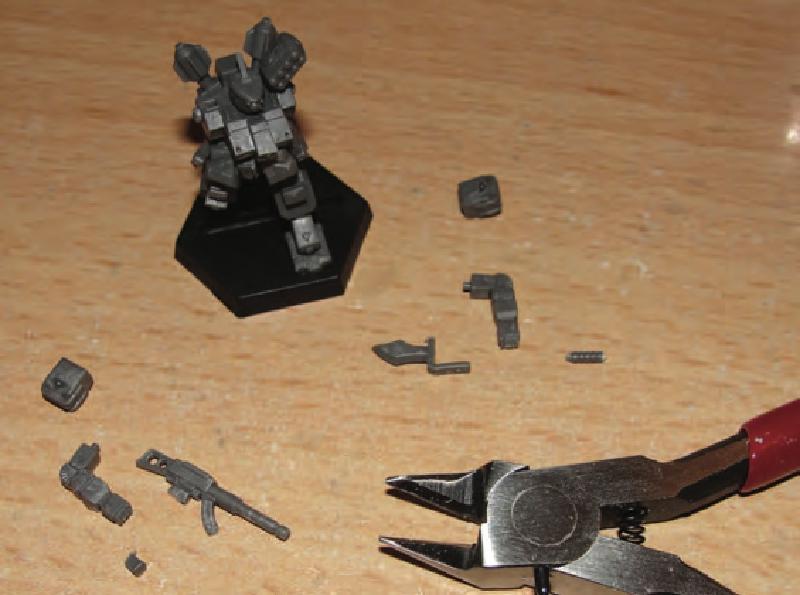 Glue head/v-engine/LRP to torso and then glue torso assembly to legs/hips assembly in desired pose and hen glue on base. Clip off weapon handles before gluing on hands.