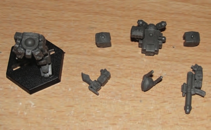 Hip armor plates glued on legs/hips and then ammo box and small box glues between side armor plates and butt plate to fill in gaps. Torso, head and arm parts prepared for final gluing.