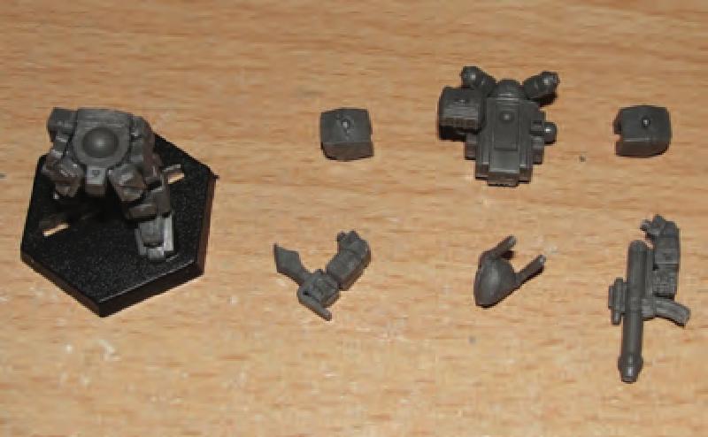 Hip armor plates glued on legs/hips and then ammo box and small box glues between side armor plates and butt plate to fill in gaps. Torso, head and arm parts prepared for final gluing.